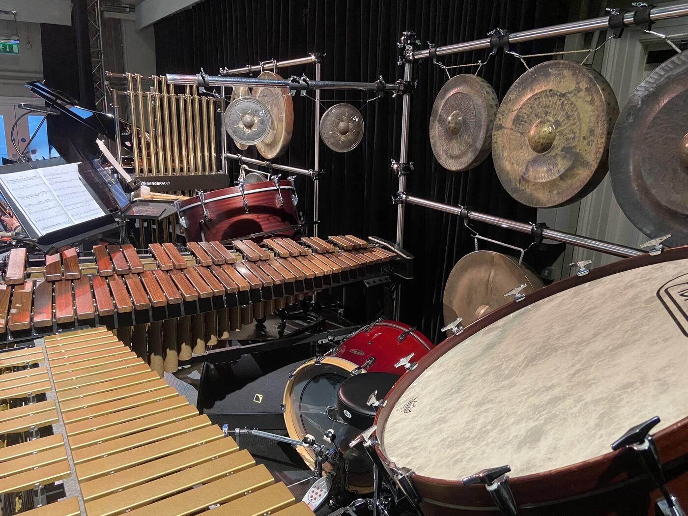 Rosewood marimba, gold vibraphone, Bergerault tubular bells and a rack of gongs set up for a concert